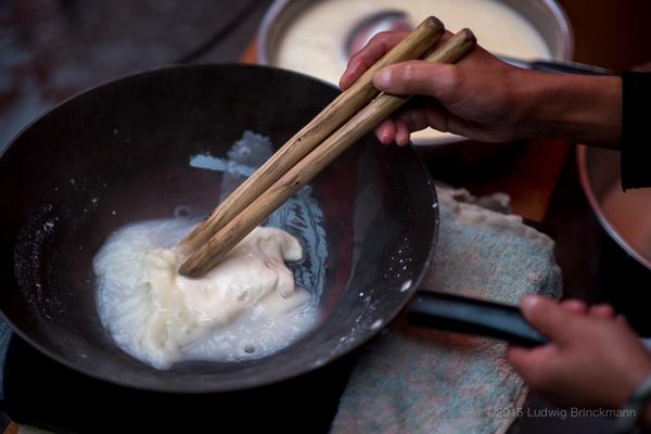 Heating and stirring until the milk becomes like mozzarella.